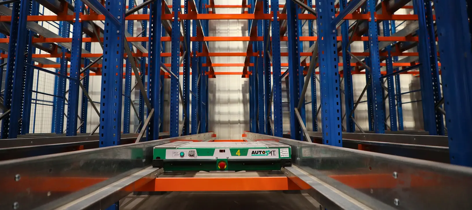 Space-saving, seismic-safe shuttle racking for a major beverage bottler